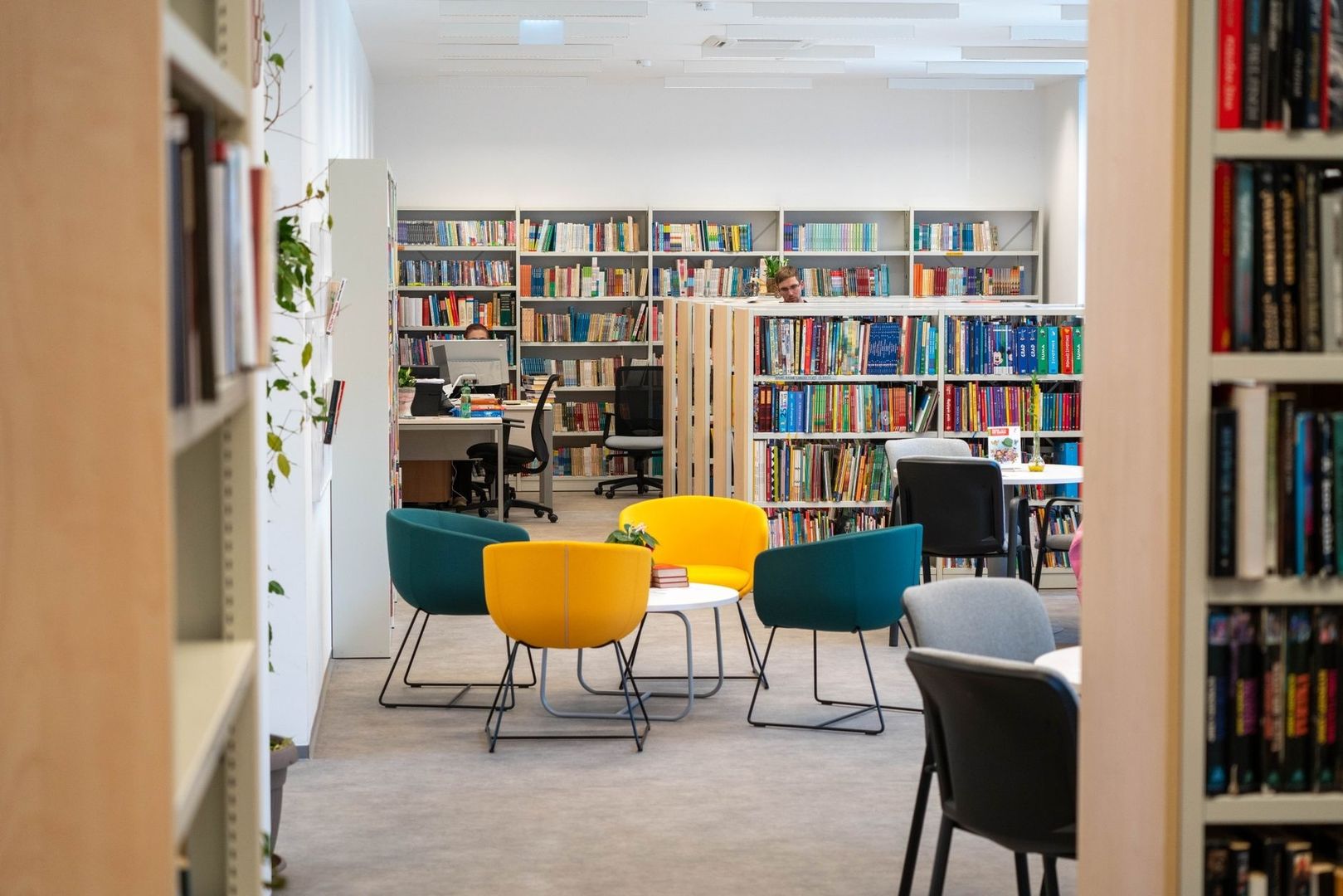 Bright public library with colorful chairs and shelves of books